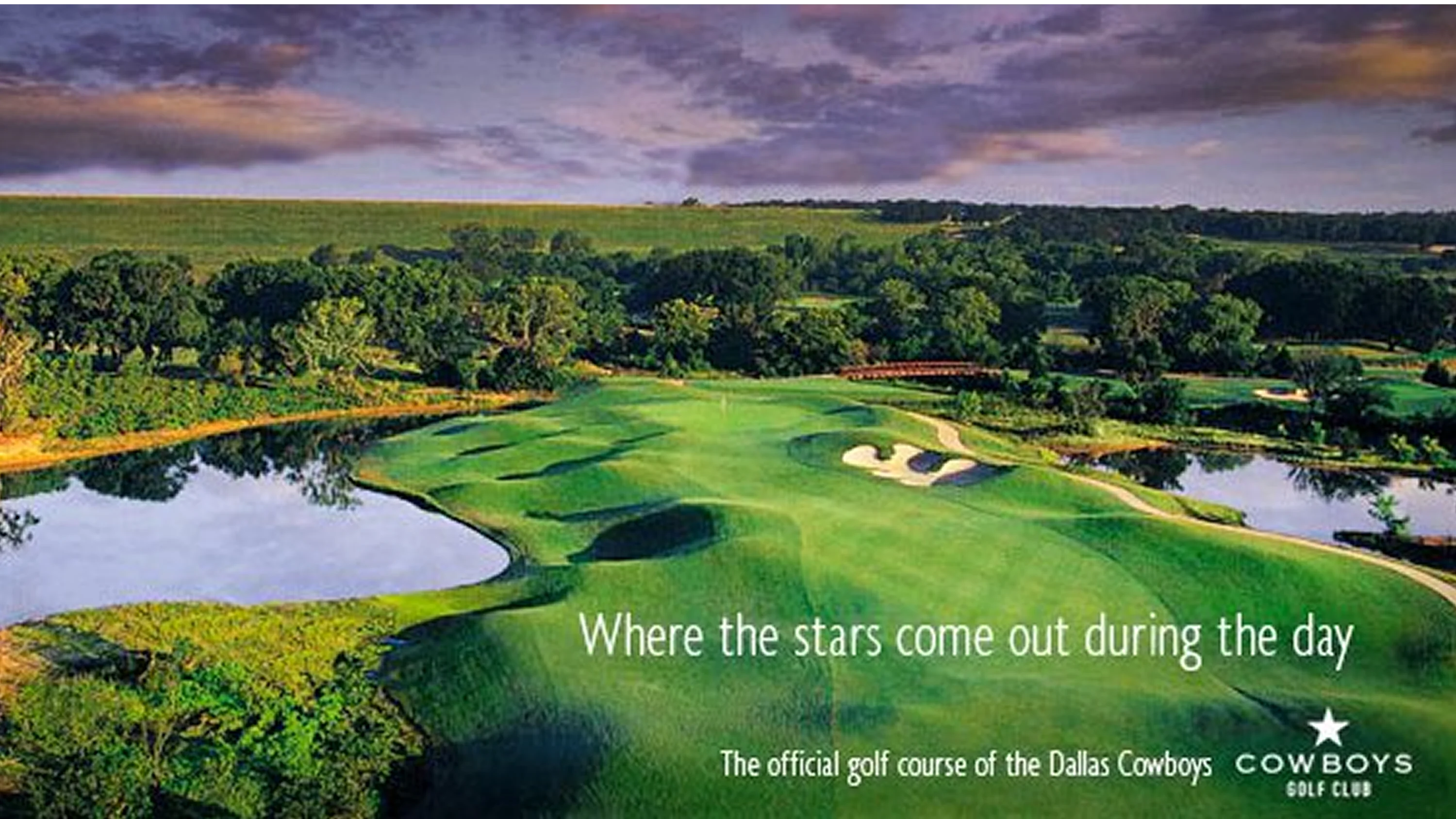 Scenic golf course at dusk with lush greenery and a water hazard.